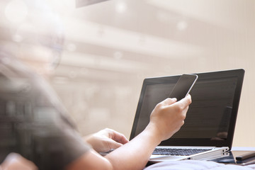 Working with smart phone and computer in bed as concept