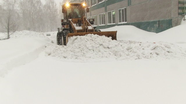 Snowplow removes a lot of snow in the 