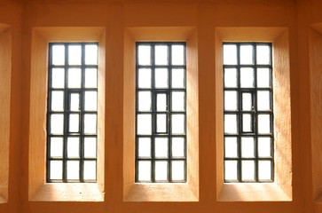 Abstract view of symmetrical windows on purple wall