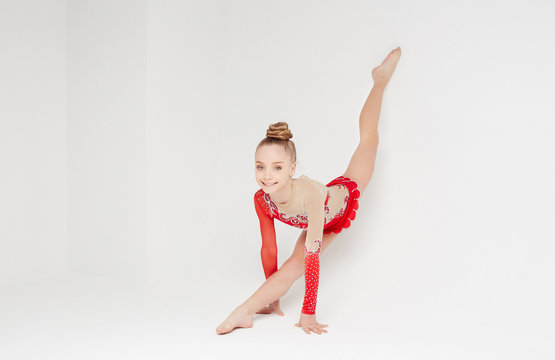 Flexible cute girl in red dress