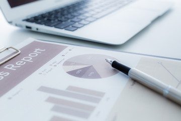 Still-life portrait of computer, pen, coffee mug on table, busin