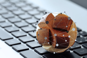 wooden texture globe with social media diagram on laptop compute