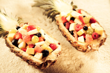 Fruit Salads in Pineapple Boats on White Sand