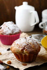 muffins with raisins on  background of  teapot