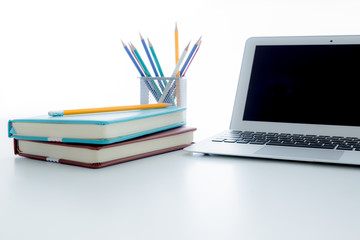 Still-life portrait of computer, pen, coffee mug on table, busin
