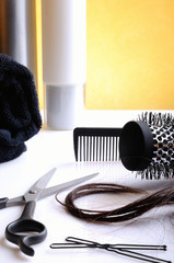 Set hairdressing articles on glass table vertical composition