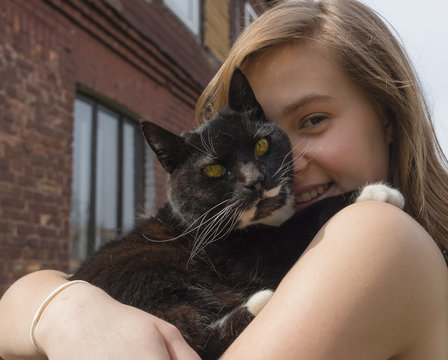 Teenager girl with black  cat