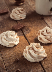 white meringue on a dark wooden background retro