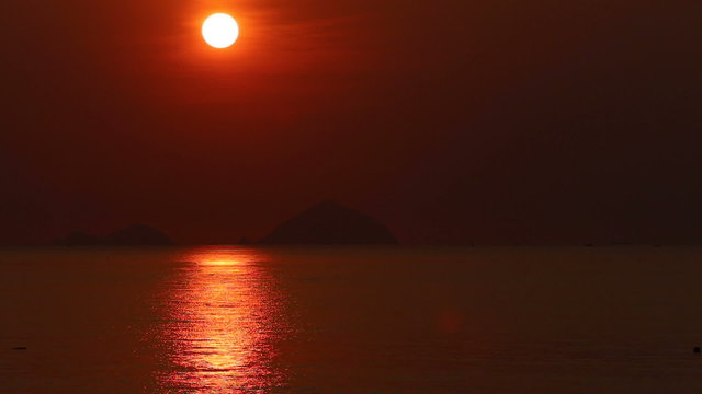 panorama of sunrise above sea at background of islands	