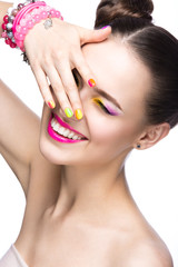 Obraz na płótnie Canvas Beautiful girl with bright colored makeup and nail polish
