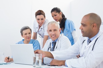 Team of doctors working on laptop