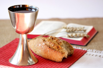 Chlice, bread an open bible