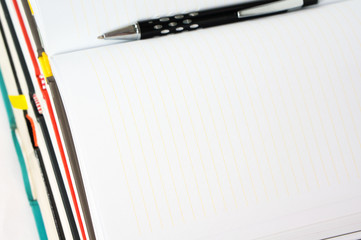 Blank notebook open with pen