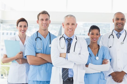 Team of smiling doctors looking at camera