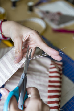 hands of Young girl making bags and accessories at home