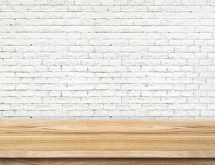 Empty wood table and white brick wall in background. product dis