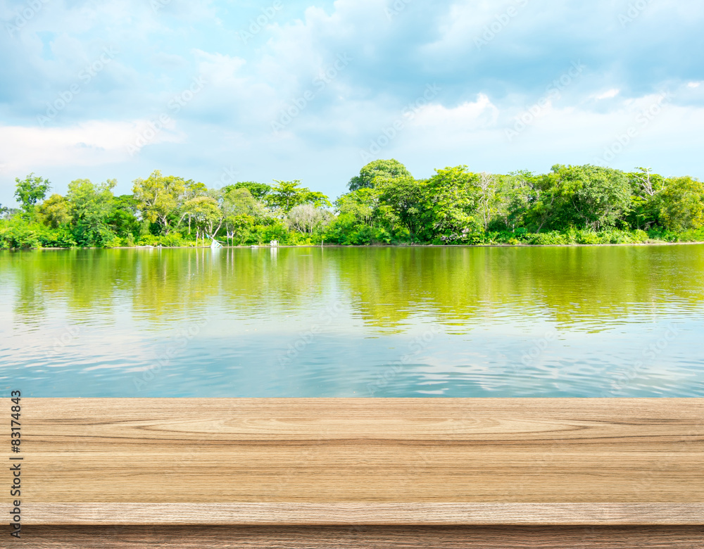 Aufkleber empty wood table with lagoon at forest and blue sky at backgroun