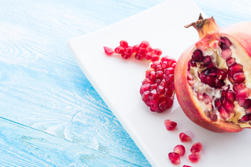 Pomegranate on plate  on  wooden background