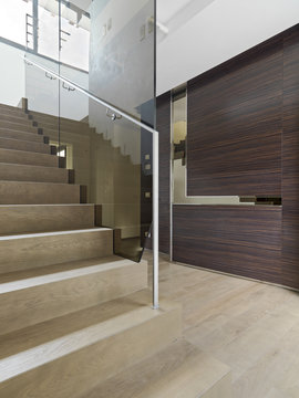 wooden staircase in the modern entrance of villa