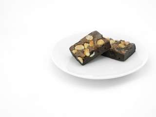 Chocolate brownie on a white plate in white background.