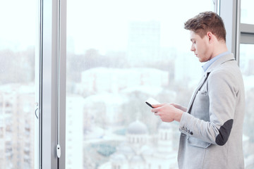 Fototapeta premium Young man standing with tablet
