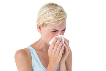 Attractive woman blowing her nose