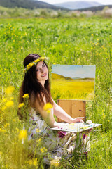 Painter woman is create picture outdoors