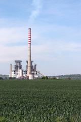 thermal power plant on green wheat field