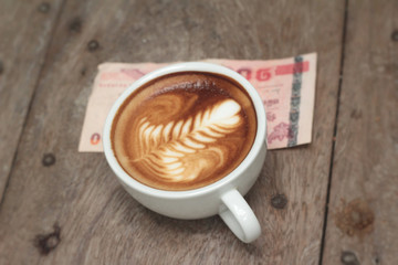 latte coffee in cup and banknote.