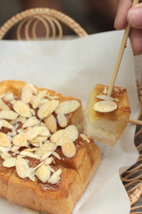 Toast topped with almonds and honey.