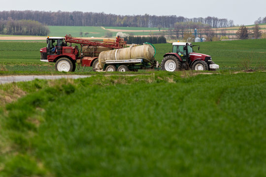 Spraying the herbicides on the green field