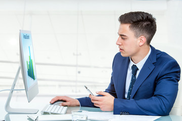 Businessman synchronizing smart phone with computer