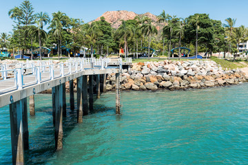 Fototapeta na wymiar View from city pier on the tropical rocky coastline