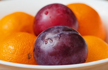 Fresh plums and tangerines