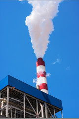 industrial smoke from chimney on blue sky