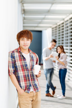 Young man with take-out coffee
