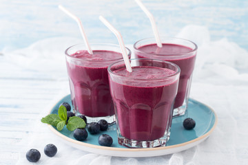Blueberry smoothie with fresh berries and sprig of mint 