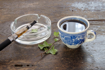 e-cigarette cup of coffee on a wooden background healthy