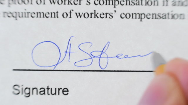 Pen signing a document