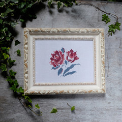 background with embroidered cross patterns of flowers roses