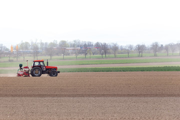 Obraz premium Tractor harrowing the field