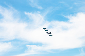 four military fighter airplanes in white clouds