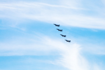 Obraz premium four military fighter aircrafts in cloudy sky
