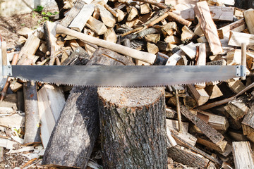 two-handled saw and cleaver in chopping bloc
