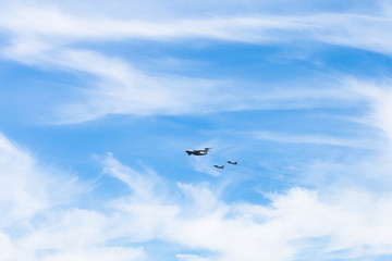 air refueling of fighter airplanes in white clouds