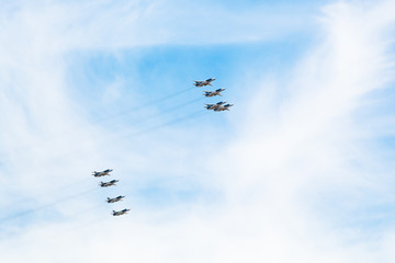 flight military pursuit aircrafts in white clouds
