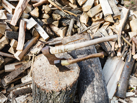 pile of wood, deck for chopping firewood, two axes