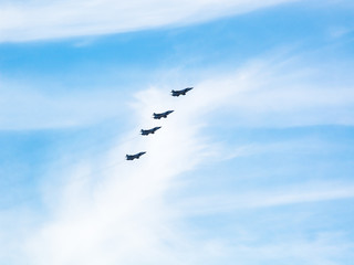 four military fighter planes in cloudy sky