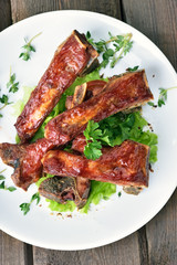 Roasted pork ribs on white plate