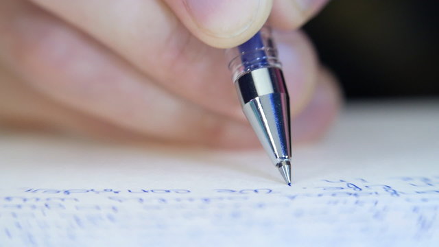 Pen writes a letter on paper